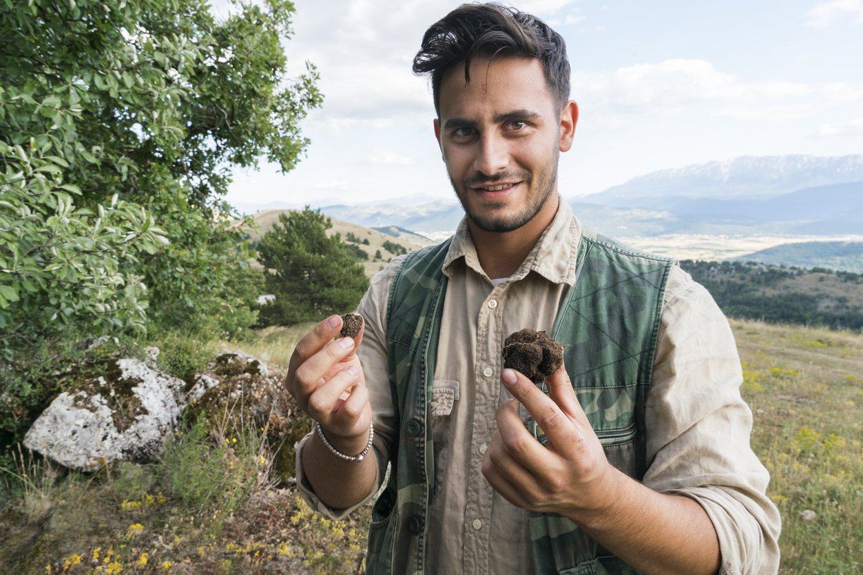Truffle hunter holding a freshly unearthed truffle during a private tour in Tuscany