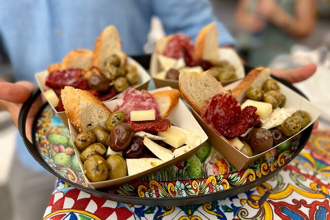 Traditional Sicilian antipasto with olives, cheese, salami, and bread